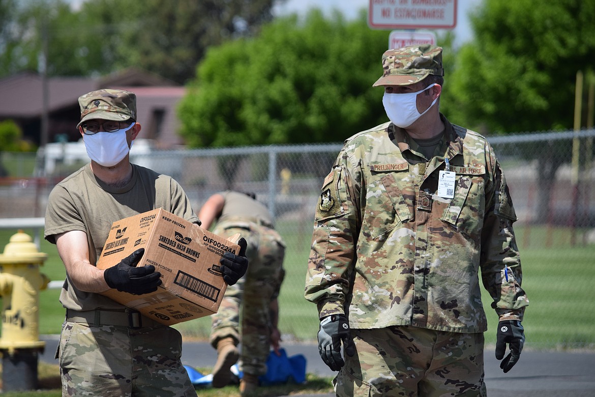 Washington Army National Guard soldiers prepare to distribute bags of frozen french fries and hash browns at Othello High School.