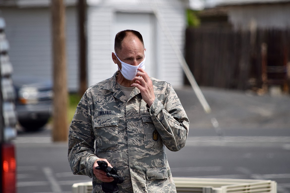 Senior Master Sgt. Donald Belfils oversees the distribution of food as part of a major giveaway by the National Guard and charity 2nd Harvest. Guard personnel gave out over 300 meal boxes and hundreds of bags of frozen potatoes to Othello area residents on Tuesday.