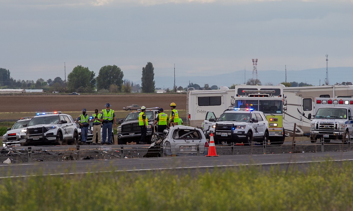 Washington State troopers and medical responders blanket the road after a fatal two-car collision roughly two miles east of Moses Lake on Interstate 90 Monday afternoon.