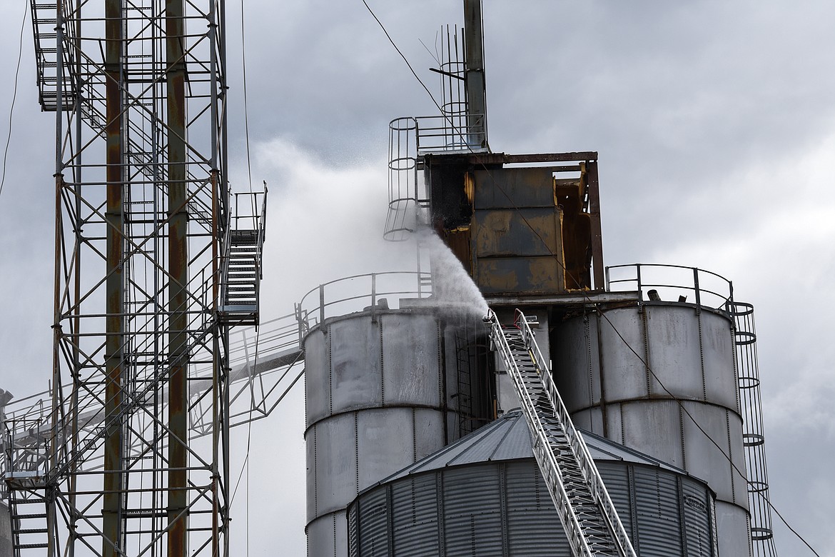 Firefighters from Kalispell Fire Department use a ladder truck to extinguish a fire at CHS Kalispell on West Center Street on Tuesday. (Casey Kreider/Daily Inter Lake)