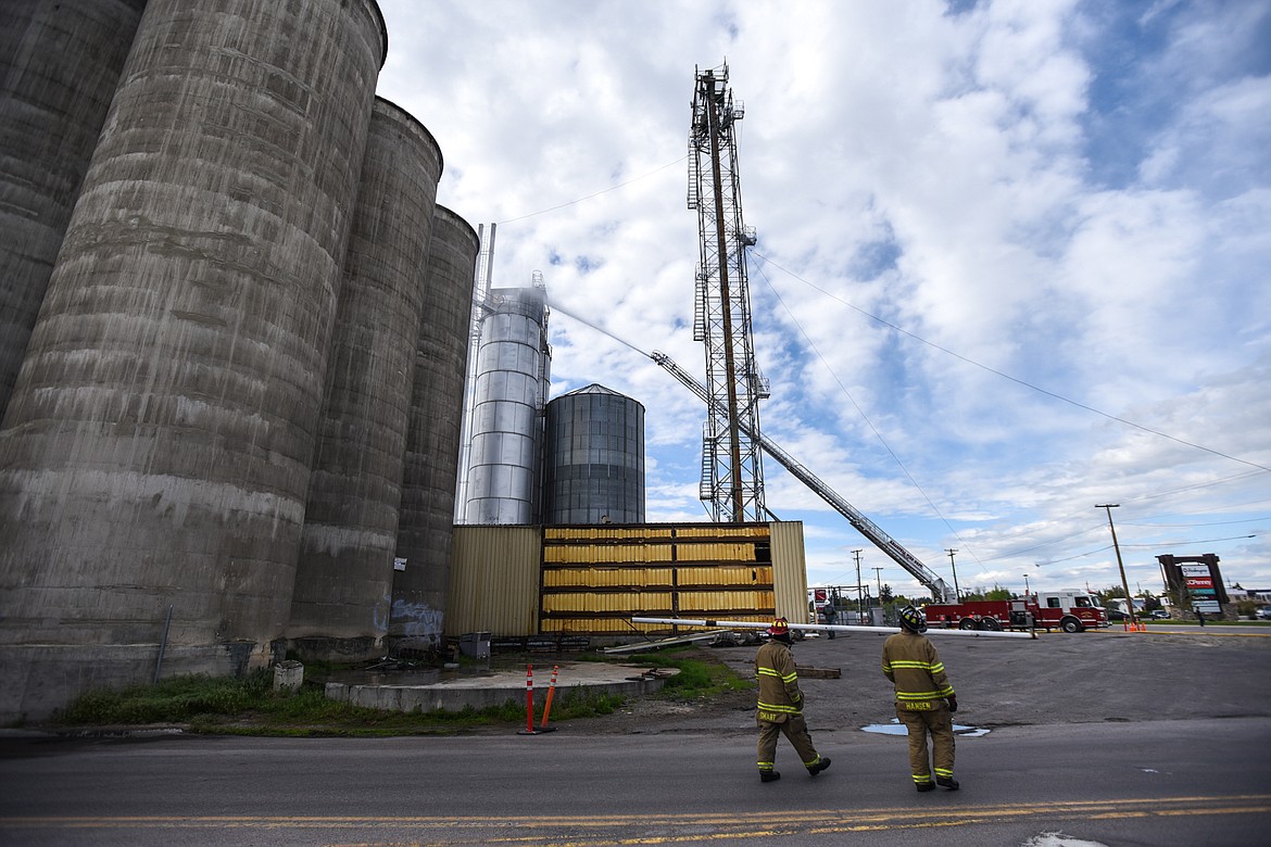 Firefighters from Kalispell Fire Department use a ladder truck to extinguish a fire at CHS Kalispell on West Center Street on Tuesday. (Casey Kreider/Daily Inter Lake)