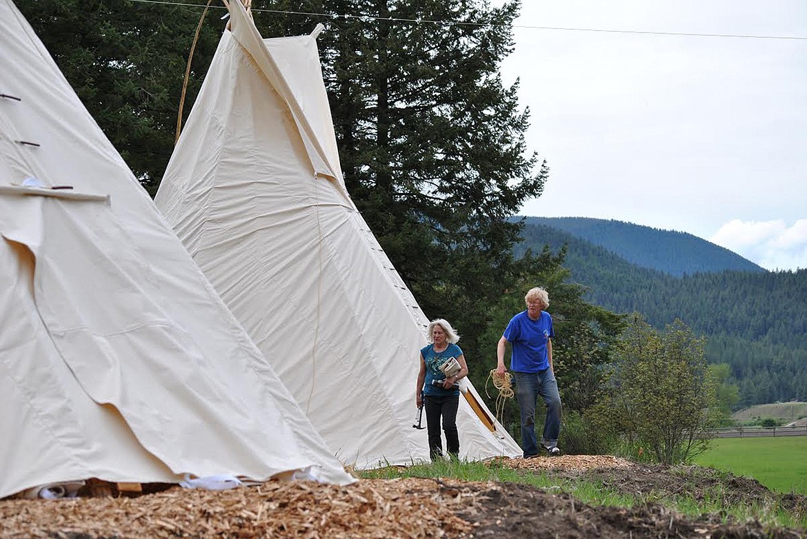 Dick Bratton and Sandy Farrell from Alpine Tipi’s wrap up finishing touches on the tipis at Sheep Mountain Lodge in Superior. (Amy Quinlivan/Mineral Independent)