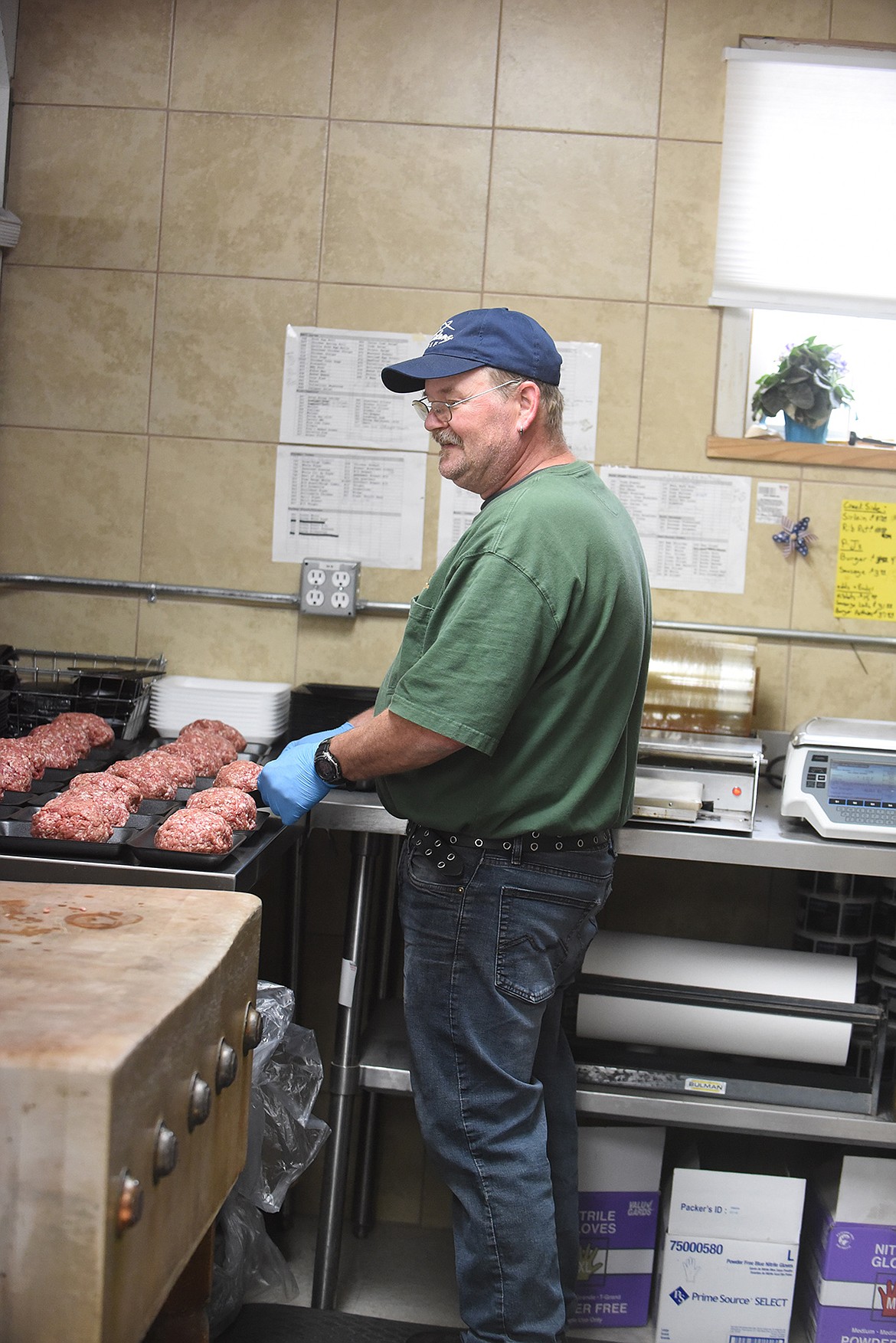 Meat department boss Michael Smale prepares the special sausage Buck’s Grocery in Hot Springs is known for making. (Scott Shindledecker/Valley Press)