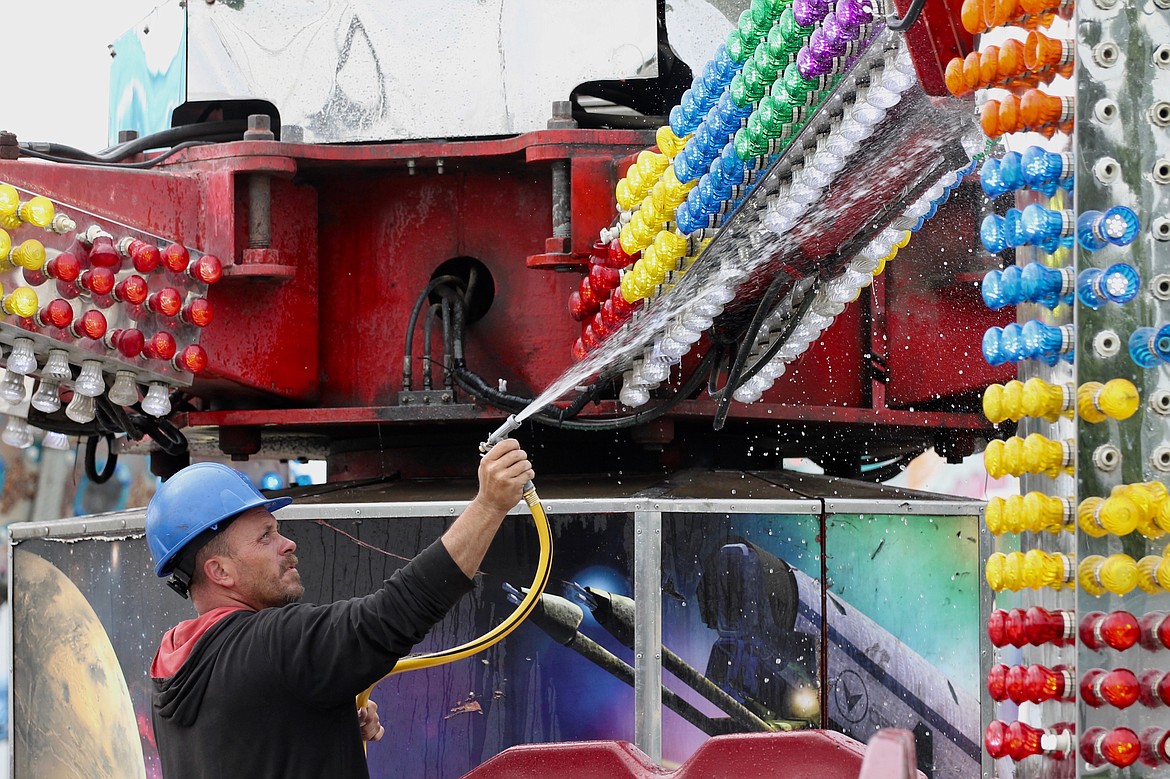 File photo 
 A carnival worker cleans up a ride prior to the 2019 Spring Festival. As of April 1, planning is continuing for the 2020 festival.