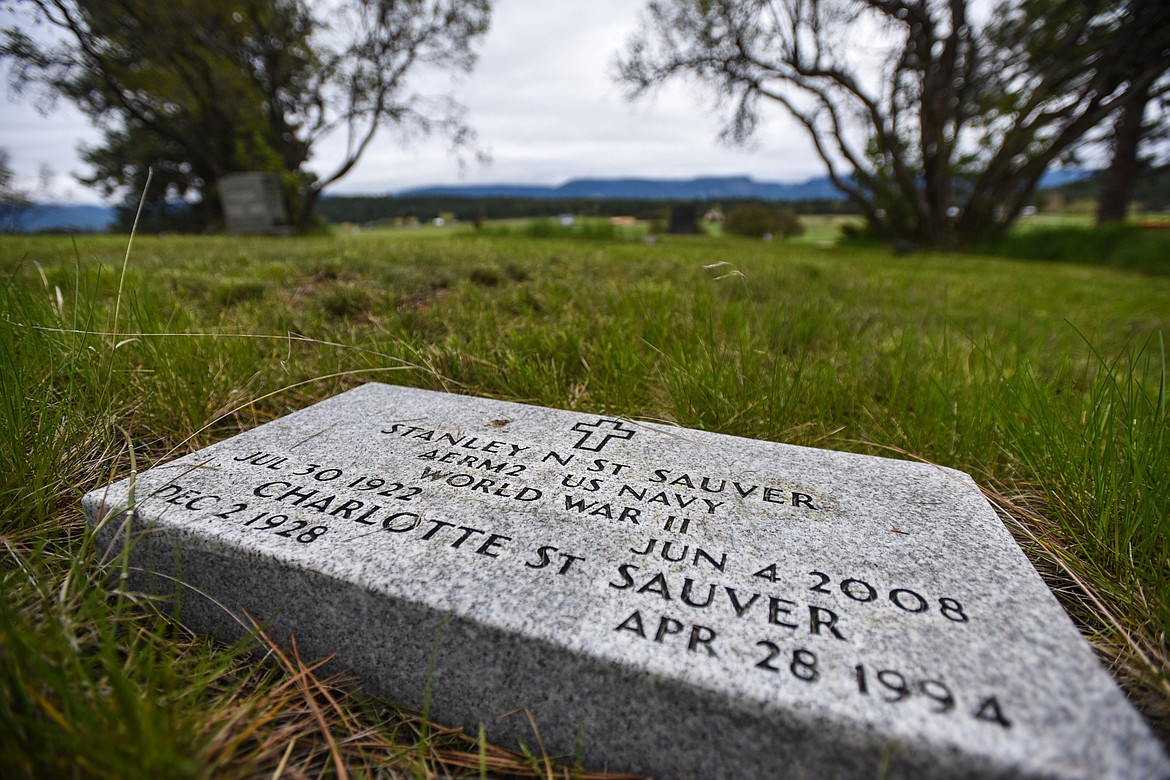 The gravestone of Stanley N. St. Sauver, a U.S. Navy veteran of World War II, and his wife, Charlotte St. Sauver, at the Lone Pine Cemetery in Bigfork on Friday, May 15. (Casey Kreider/Daily Inter Lake)