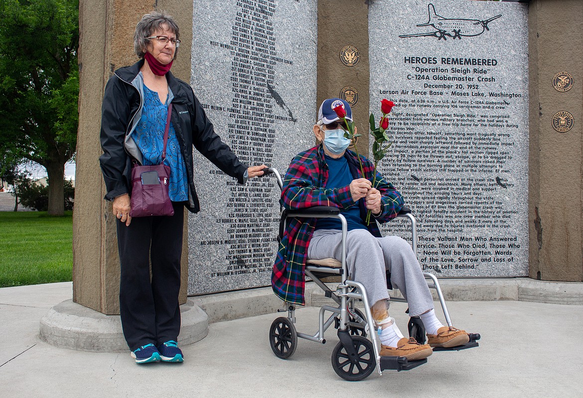 Ralph Boyden (right) prepares to lay roses at a memorial to 87 military service members killed in a 1952 airplane accident at Larson Air Force Base in Moses Lake. Boyden is accompanied by his daughter LeeAnne Austin. He was one of the first people on the scene after the accident.