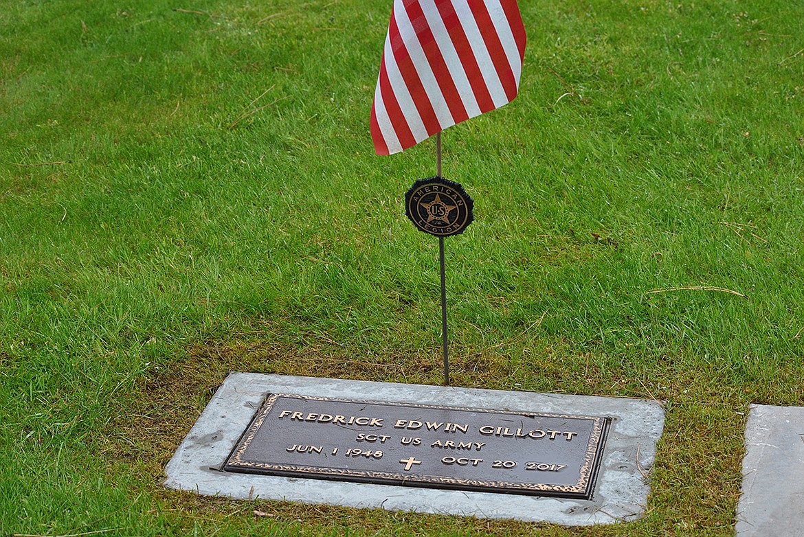 A flag stands over American Legion member, and U.S. Army Sergeant Frederick Gillott’s headstone at the St. Regis Cemetery. (Amy Quinlivan/Mineral Independent)