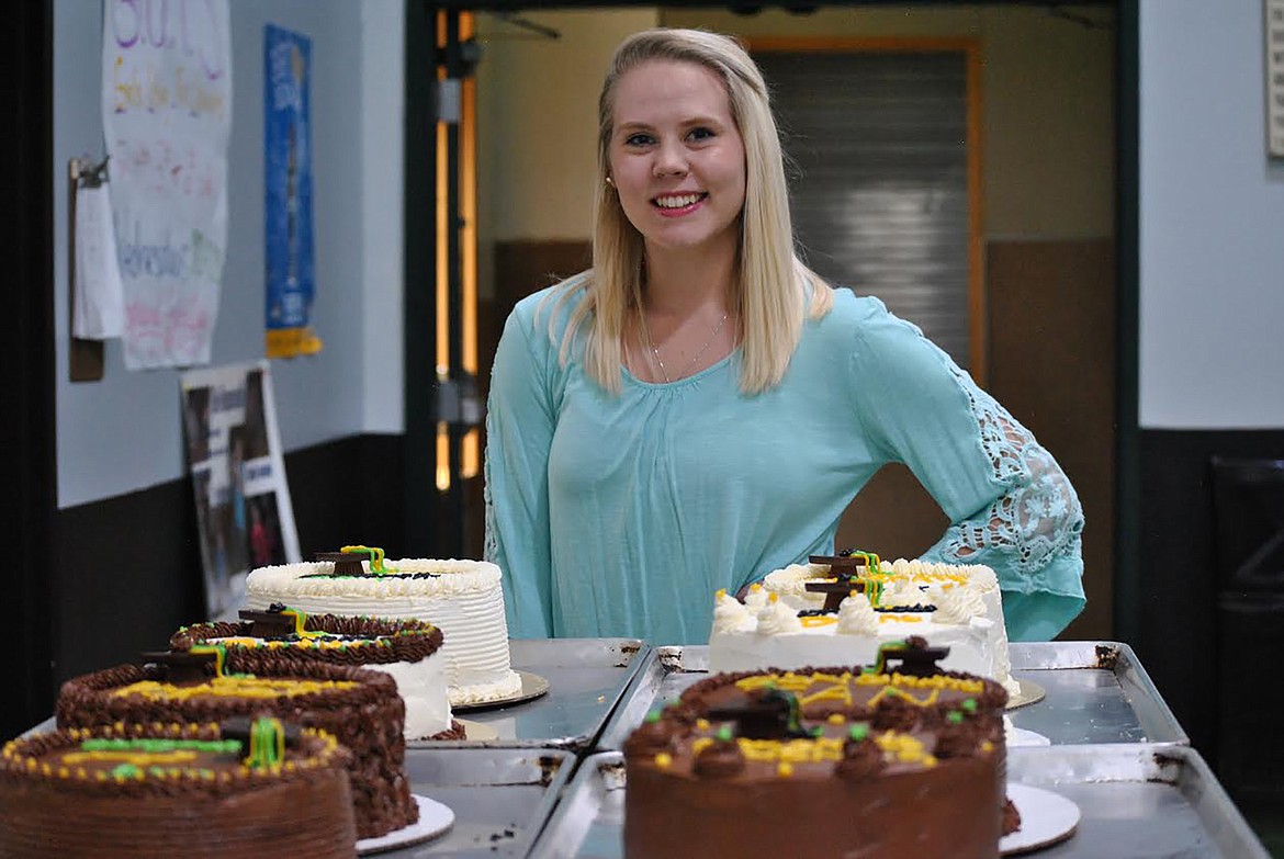 Emma Hill shows off the individual cakes she prepared for the St. Regis graduates. (Amy Quinlivan/Mineral Independent)