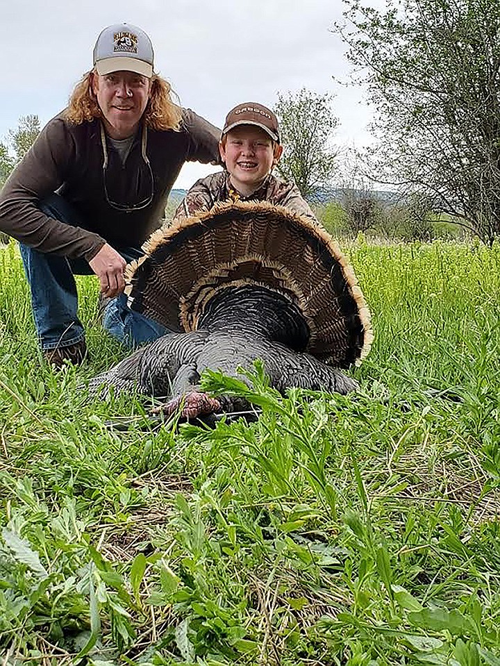 Superior residents Scot Traeder and his son Truman show off the spring gobbler Scot bagged recently. (Photo submitted)