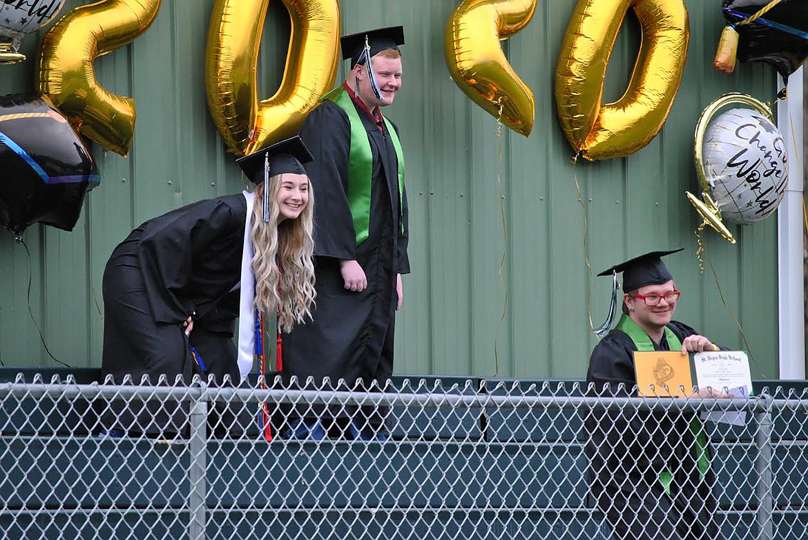 Kylee Thompson and Duane Terry “photobomb” as Thomas Sayer poses with his diploma at the 2020 St. Regis High School graduation. (Amy Quinlivan/Mineral Independent)