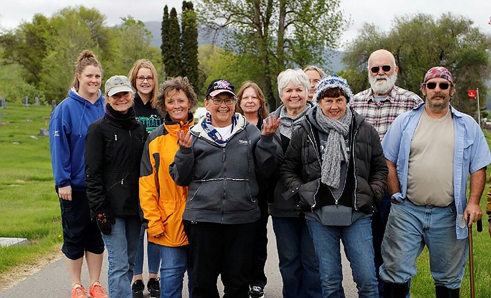 The Plains community helped the VFW Post 3596 Auxiliary plant flags next to gravemarkers of former members. From left,  front row are Becky Powley, Cindy Gray and Ed Foste.  From left, back row, ar️e Katie Gonce and daughter Lexie, Kim Foust, Marie Evans, Karol Williamson, Sherryl Wachob, Kathy Warrington and Tom Wachob. Others not pictured whom helped are Sue Bartholomeu, Carol Harris and granddaughters Layla and Ceci, and Rick Williamson. VFW Auxiliary members included Powley, Gray, Harris, Bartholomeu and Warrington. (Submitted photo)