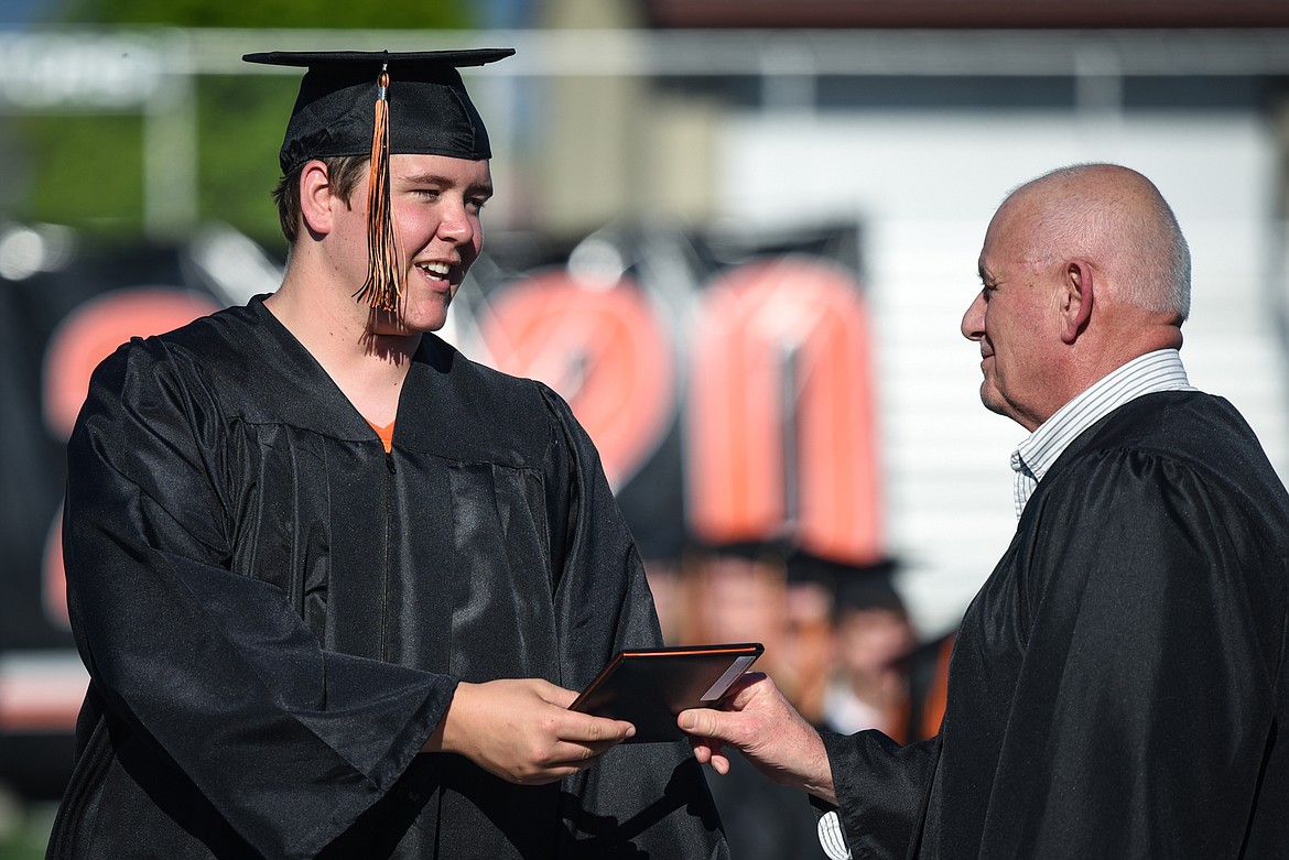 Graduate Max Anderson receives his diploma at the Flathead High School Class of 2020 commencement ceremony at Legends Stadium on Friday, May 29. (Casey Kreider/Daily Inter Lake)