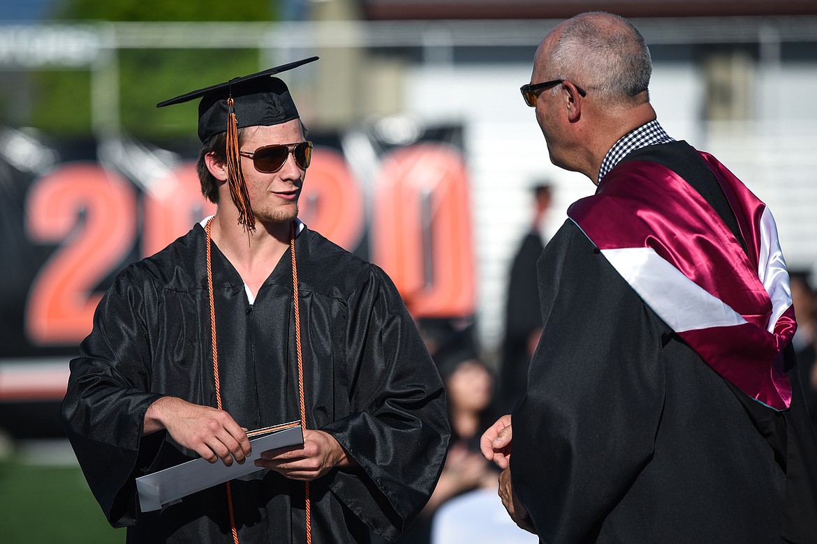 Graduate Tanner Russell receives his diploma from superintendent Mark Flatau at the Flathead High School Class of 2020 commencement ceremony at Legends Stadium on Friday, May 29. (Casey Kreider/Daily Inter Lake)