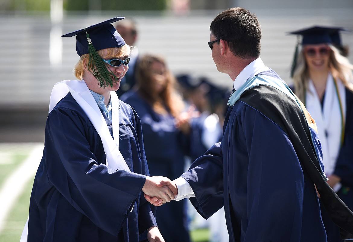 Graduate Luke Baker receives his diploma from principal Micah Hill at the Glacier High School Class of 2020 commencement ceremony at Legends Stadium on Saturday, May 30. (Casey Kreider/Daily Inter Lake)