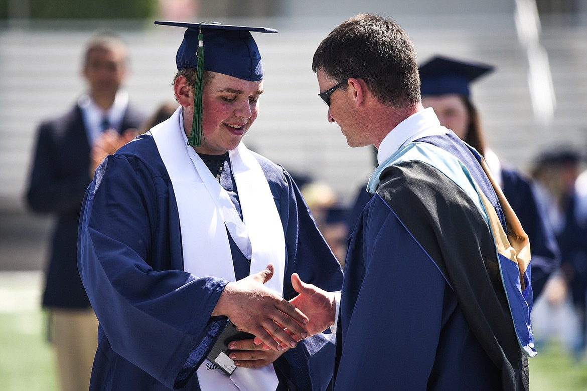 Graduate Derek Ambrose receives his diploma from principal Micah Hill at the Glacier High School Class of 2020 commencement ceremony at Legends Stadium on Saturday, May 30. (Casey Kreider/Daily Inter Lake)