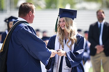 Graduate Addison Labrum receives her diploma from Mark Dennehy, assistant principal and activities director, at the Glacier High School Class of 2020 commencement ceremony at Legends Stadium on Saturday, May 30. (Casey Kreider/Daily Inter Lake)