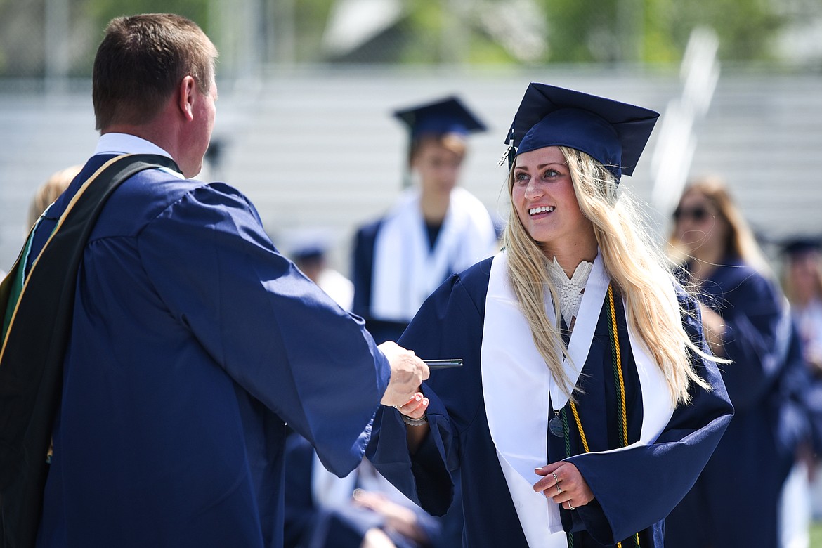 Graduate Abigale Manger receives her diploma from Mark Dennehy, assistant principal and activities director, at the Glacier High School Class of 2020 commencement ceremony at Legends Stadium on Saturday, May 30. (Casey Kreider/Daily Inter Lake)