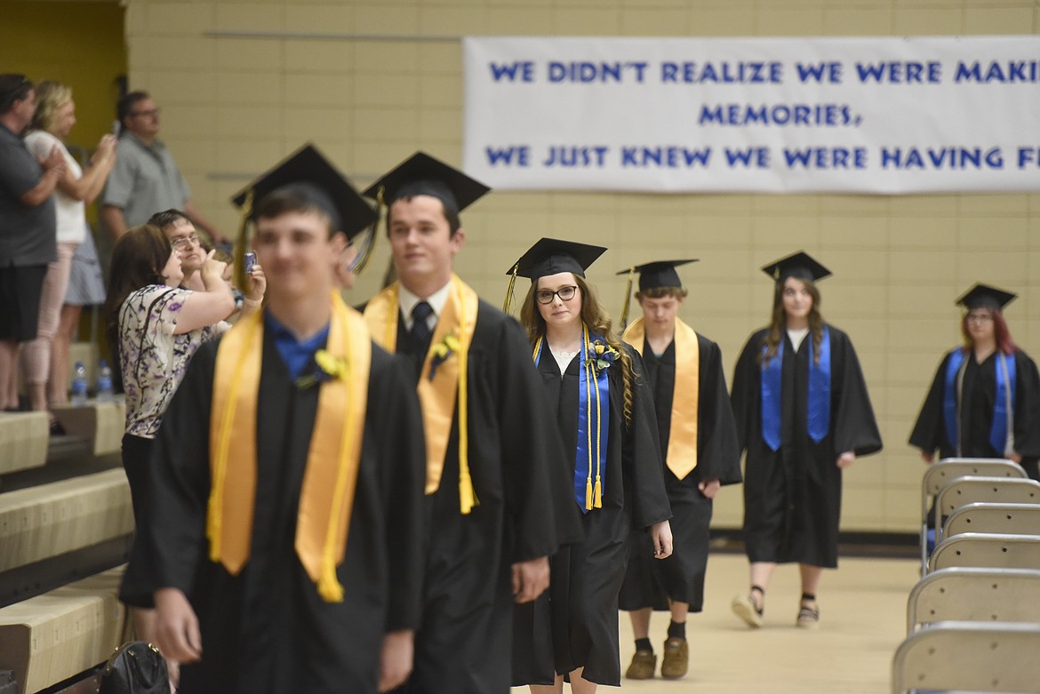 Graduates filter into Libby’s Ralph Tate Gymnasium on May 30 to mark the completion of high school. School officials elected months ago to go ahead with the ceremony despite pandemic restrictions. (Derrick Perkins/The Western News)