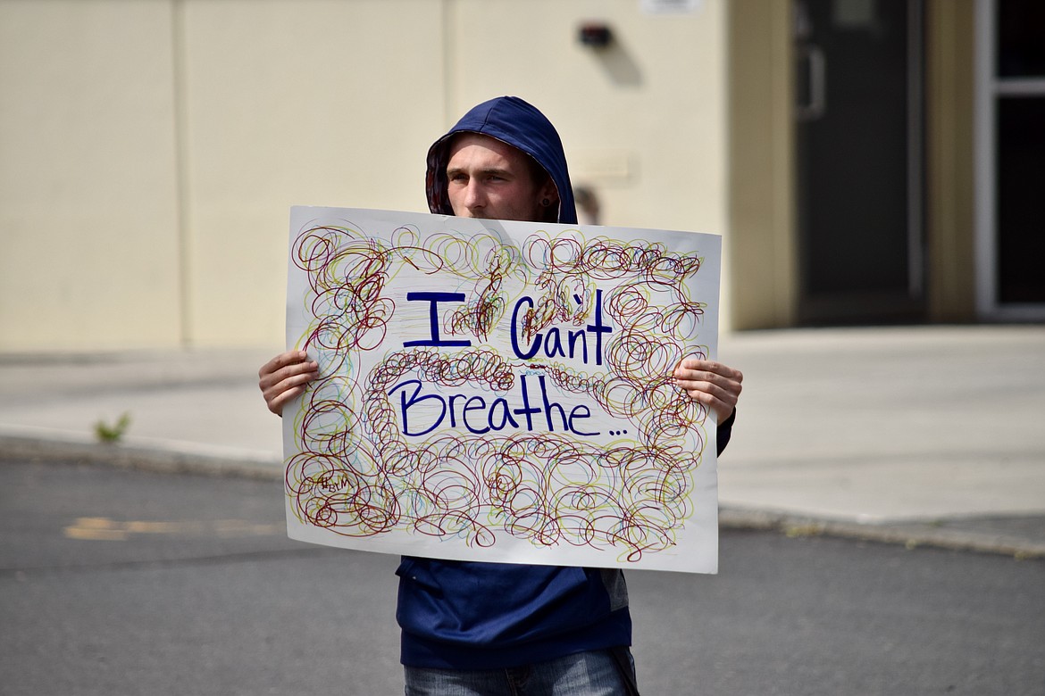 Jonathan Palmer, 22, holds up a sign outside the Moses Lake Public Library on Tuesday afternoon echoing the words of George Floyd, who died in an incident with Minneapolis police May 25.