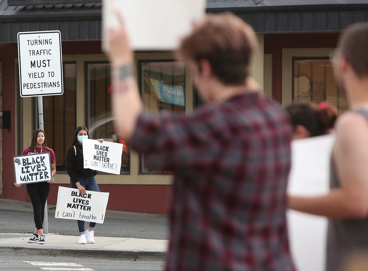 Connor Vanderweyst/Columbia Basin Herald
Protesters flanked the intersection of Broadway Avenue and Stratford Road on Tuesday night in Moses Lake.