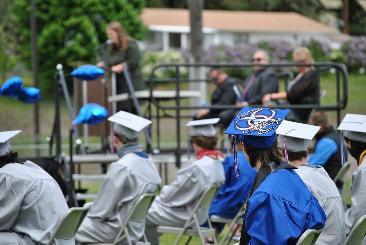 Superior graduate Dani Vanderploeg's cap read "Caution still contagious #CO19.” Her and her classmates look on as keynote speaker Angie Armour addresses the graduates May 24.  (Amy Quinlivan/Mineral Independent)