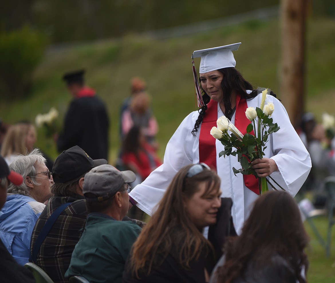 HOT SPRINGS High School’s McKennzie Cannon tears up as she presents white roses to her family members during graduation ceremonies Sunday, May 24. (Scott Shindledecker/Valley Press)