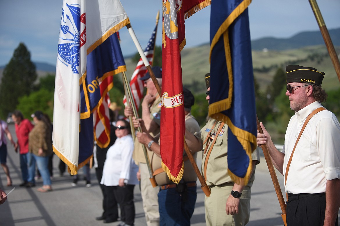 PLAINS VFW and Auxiliary members present colors during their ceremony at the Clark Fork River bridge last Saturday. The event was well attended by veterans and community members. (Scott Shindledecker/Valley Press)