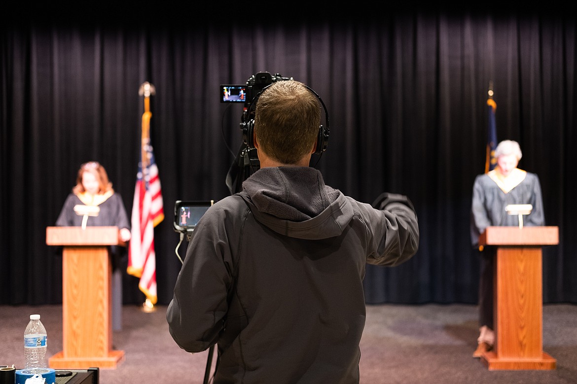 Jake Cooke directs teachers Jacqueline Gaertner and Chris Schwaderer during the filming of the 2020 graduation video. (Daniel McKay/Whitefish Pilot)