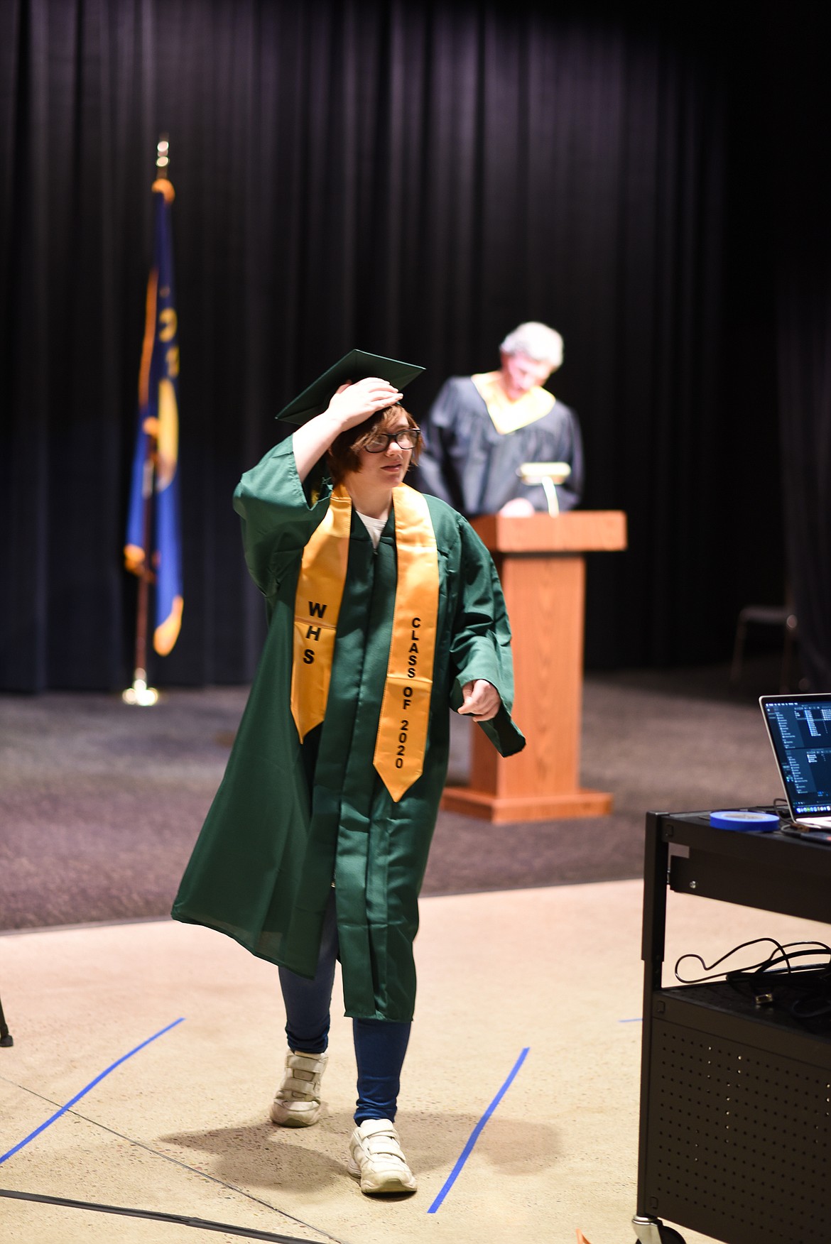 Constance Larsen walks off camera after moving her tassel during the filming of the 2020 graduation video. (Daniel McKay/Whitefish Pilot)