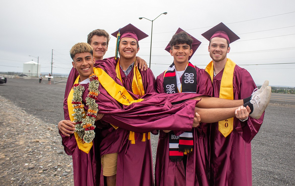 Casey McCarthy/Columbia Basin Herald 
 Moses Lake graduates pose for a photo at Grant County Fairgrounds before Friday's parade began.