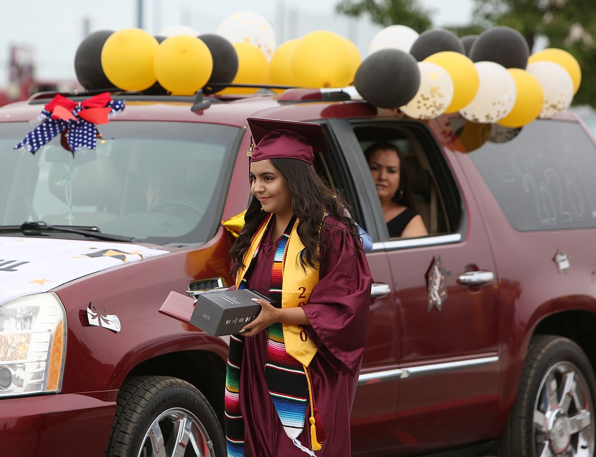 Connor Vanderweyst/Columbia Basin Herald 
 A Moses Lake High School graduate waits to be picked up after getting her picture taken and receiving her diploma on Friday.