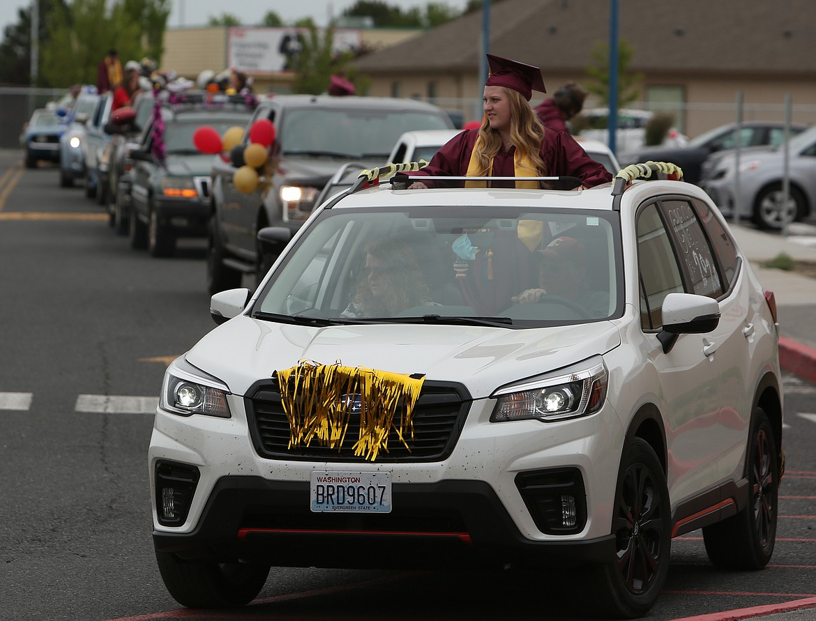 Connor Vanderweyst/Columbia Basin Herald 
 Cars line the parking lot of Moses Lake High School as graduates wait to get their picture taken and receive their diploma.