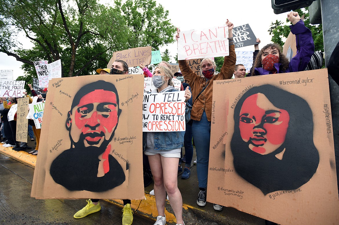 Protesters hold signs depicting George Floyd and Breonna Taylor during a protest denouncing police violence against people of color at Depot Park in Kalispell on Saturday, June 6. (Casey Kreider/Daily Inter Lake)