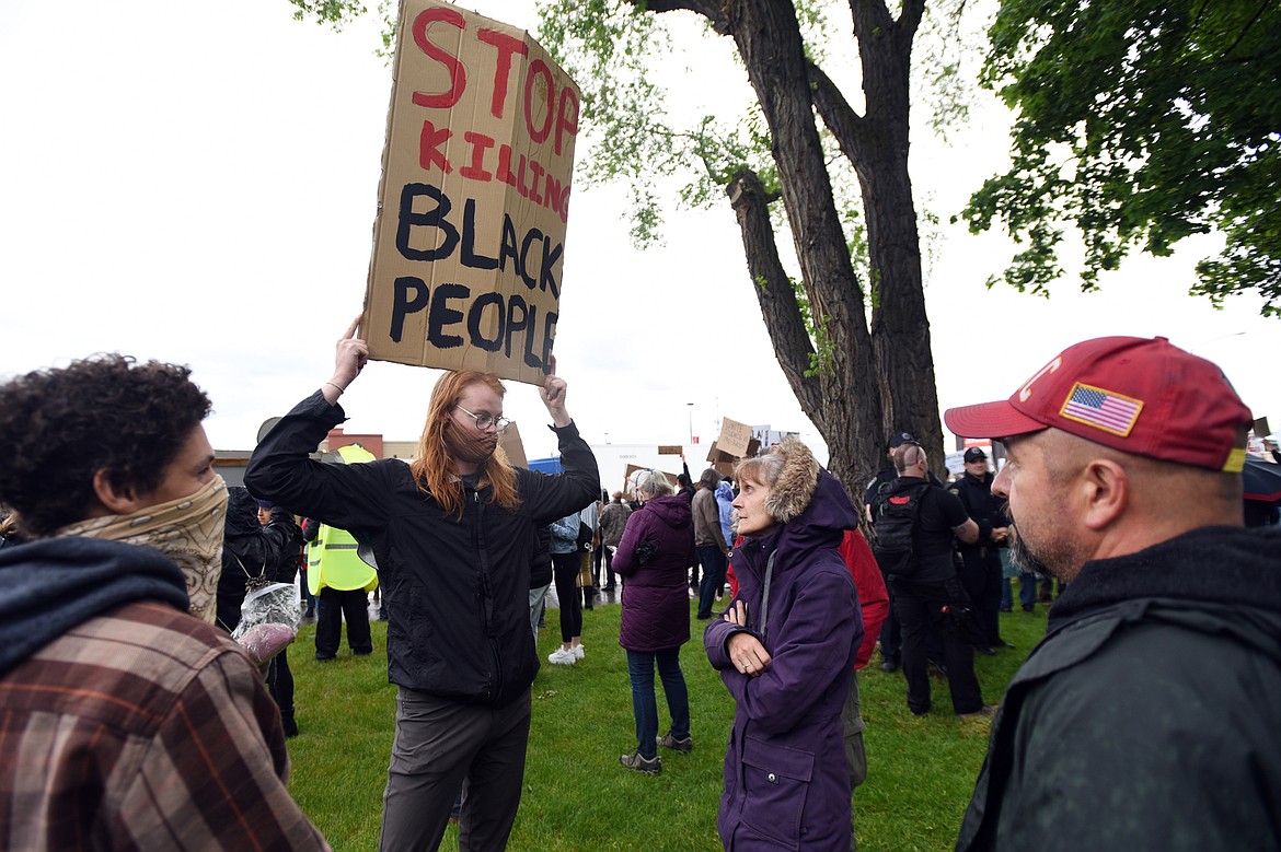 Protesters converse with people gathered to protect the Veterans Monument at Depot Park in Kalispell during a protest denouncing police violence against people of color on Saturday, June 6. (Casey Kreider/Daily Inter Lake)