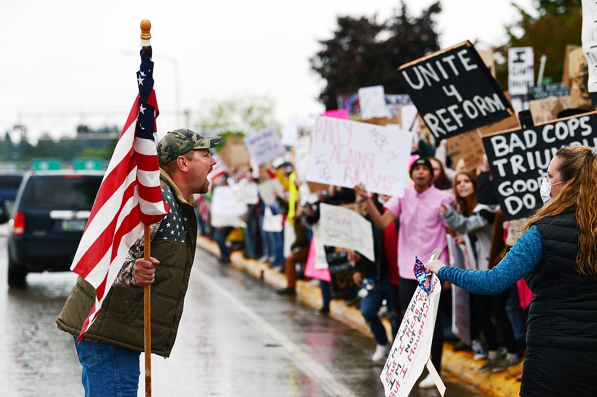 A man gets out of a pickup truck to yell at protesters gathered along North Main Street at Depot Park during a protest denouncing police violence against people of color in Kalispell on Saturday, June 6. (Casey Kreider/Daily Inter Lake)