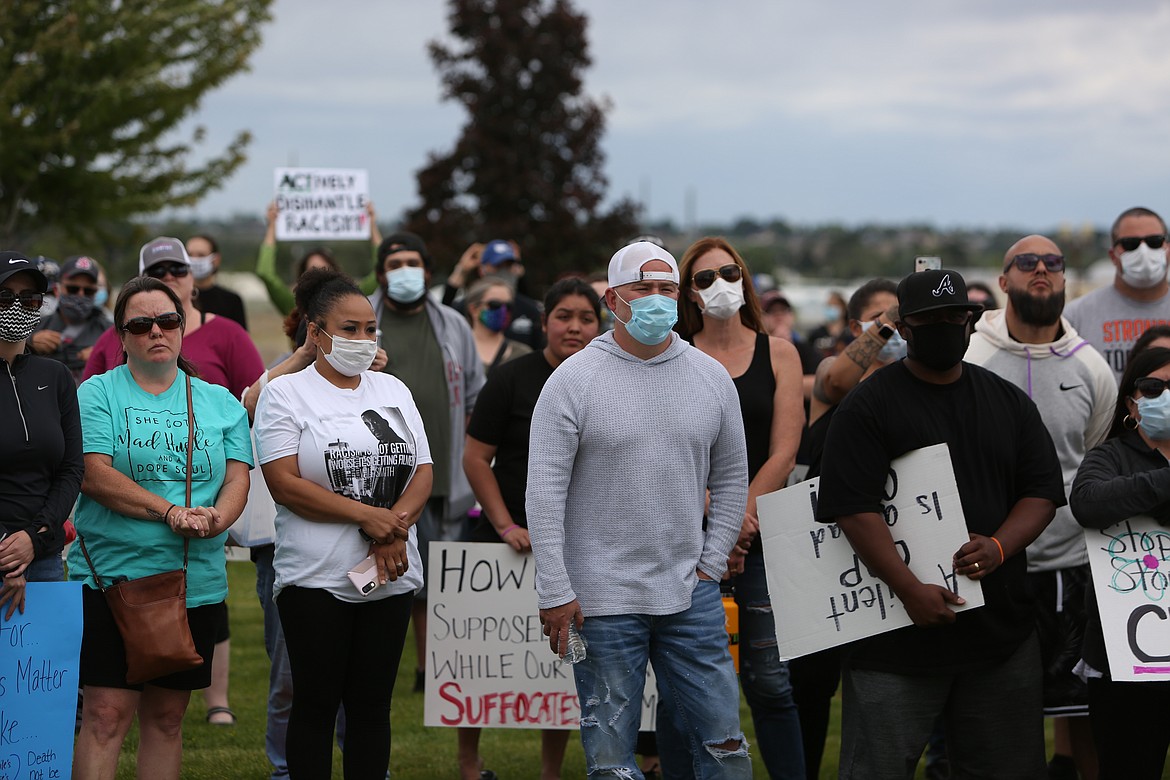 Emry Dinman/Columbia Basin Herald Attendees at Sunday's march look up at Baleigh Sampson, one of the event's organizers, as she spoke about police brutality and the march's purpose.