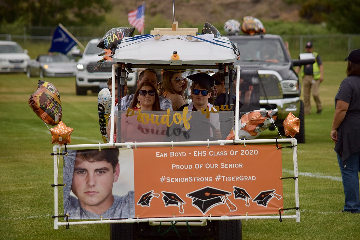Charles H. Featherstone/Columbia Basin Herald 
 Ean Boyd and his family in "The Boydmobile," the golf cart his parents rented for graduation.
