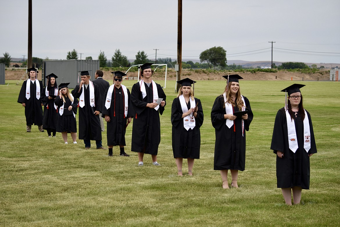 Charles H. Featherstone/Columbia Basin Herald 
 Ephrata High School graduates line up while maintaining social distancing.