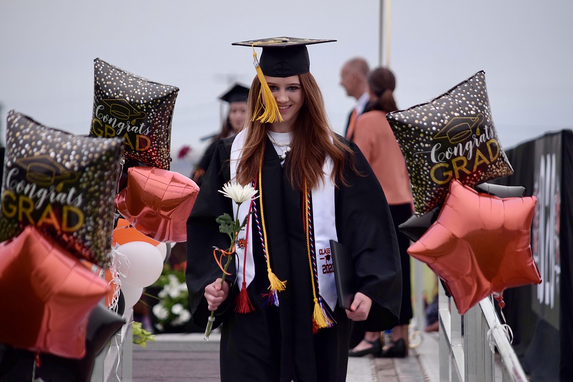 Charles H. Featherstone/Columbia Basin Herald 
 Epherata High School senior Katey Stewart descending the stage after being recognized at EHS's drive-in graduation ceremony on Friday.