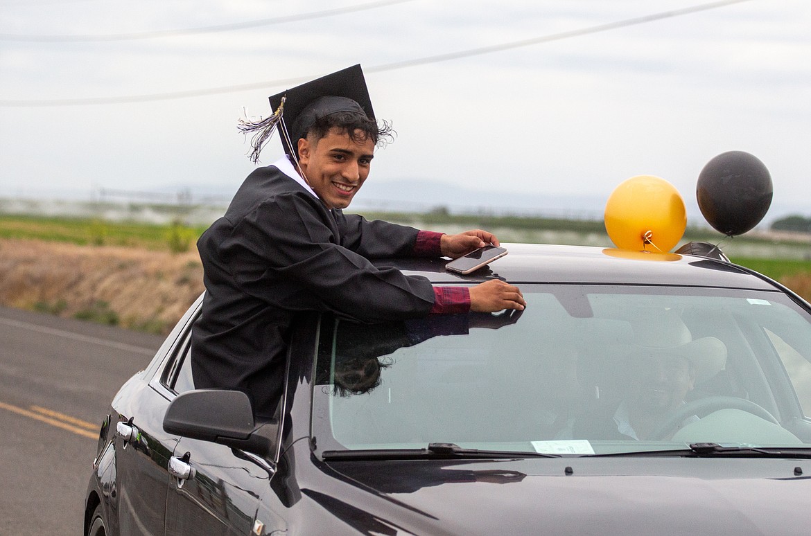 A Royal graduate makes his way down the road during the school’s graduation parade to kick off their celebration of the 2020 class on Friday.