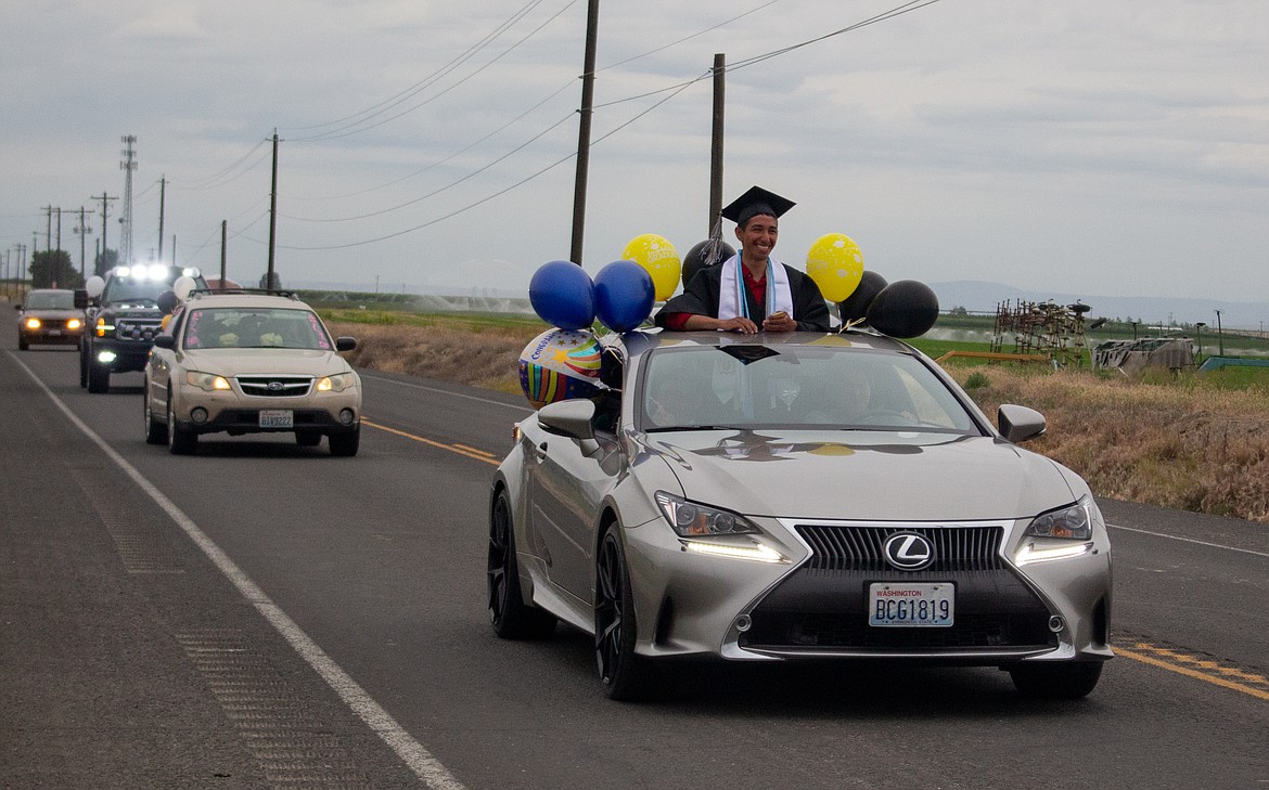 2020 Royal High School graduates make their way down the road during the graduation parade in Royal City on Friday evening.
