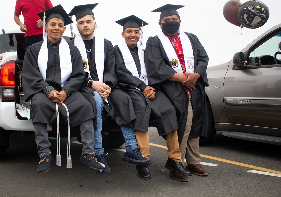 Royal High School graduating seniors gather together for a photo in the parking lot before the parade and ceremonies get underway Friday evening.