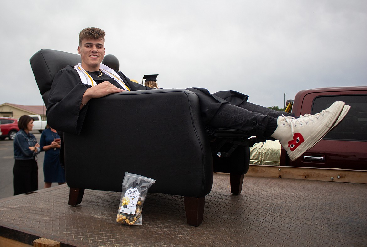 Royal graduate Carter Dorsing kicks back with a snack in the parking lot before graduation celebrations begin on Friday night.