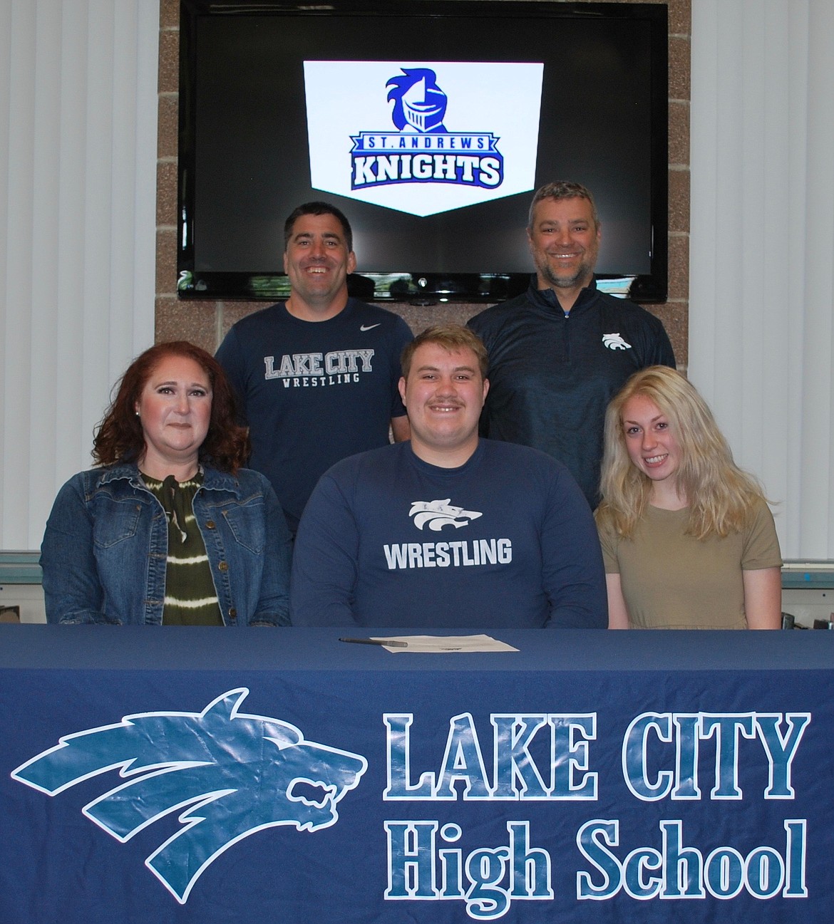 Lake City High senior Owen Hughes recently signed a letter of intent to wrestle at NAIA St. Andrews University in Laurinburg, N.C. Seated from left are Mercedes Hughes (mom), Owen Hughes and Morgan Hughes (sister); and standing from left, Corey Owen, Lake City High head wrestling coach; and Bryan Kelly, Lake City High assistant principal.