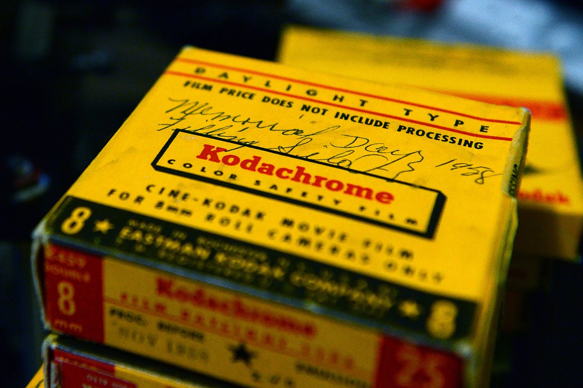 Boxes of Kodachrome 8mm film with "process before" dates in the late 1950s wait to be digitized next to Eric Bruer's Elmo K100 SM projector film chain at his residence near Bigfork on Friday, June 5. The top box contained film from a family's Memorial Day gathering in May of 1958. (Casey Kreider/Daily Inter Lake)