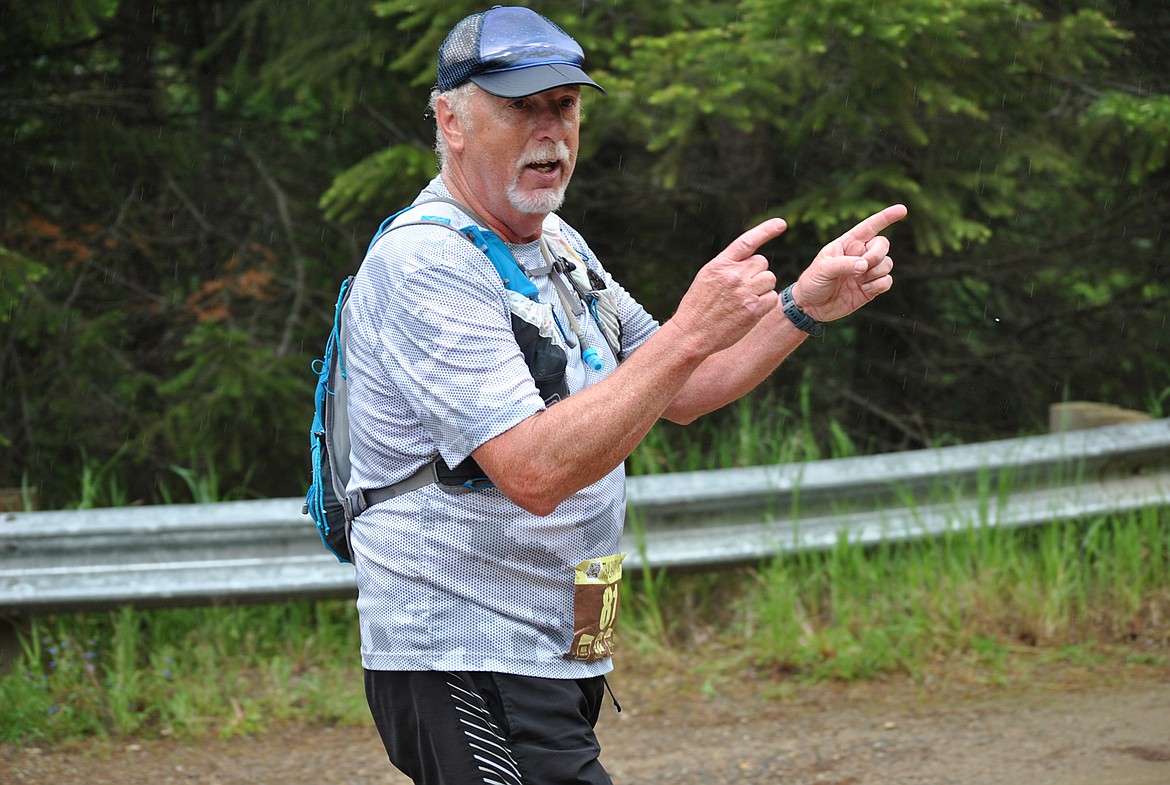 50K runner Mitch Carlton from Billings passes the Ward Creek aid station while joking “This way right?” As he ran by, he also added that instead of ringing cowbells spectators should use train whistles because he thought that would be more fitting for this race. (Amy Quinlivan/Mineral Independent)