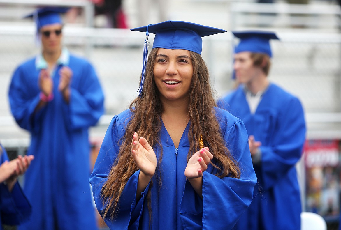 Bigfork High School graduates clap at the end of graduation speeches.