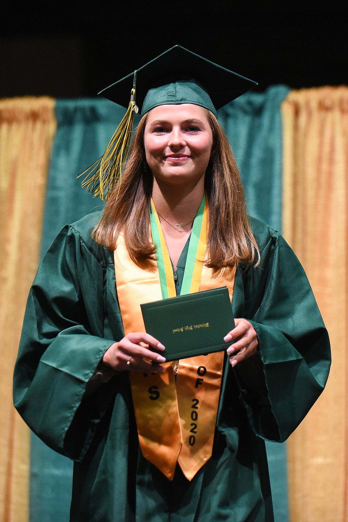 Claire Carloss poses with her diploma during Saturday's Whitefish High School Graduation. (Daniel McKay/Whitefish Pilot)