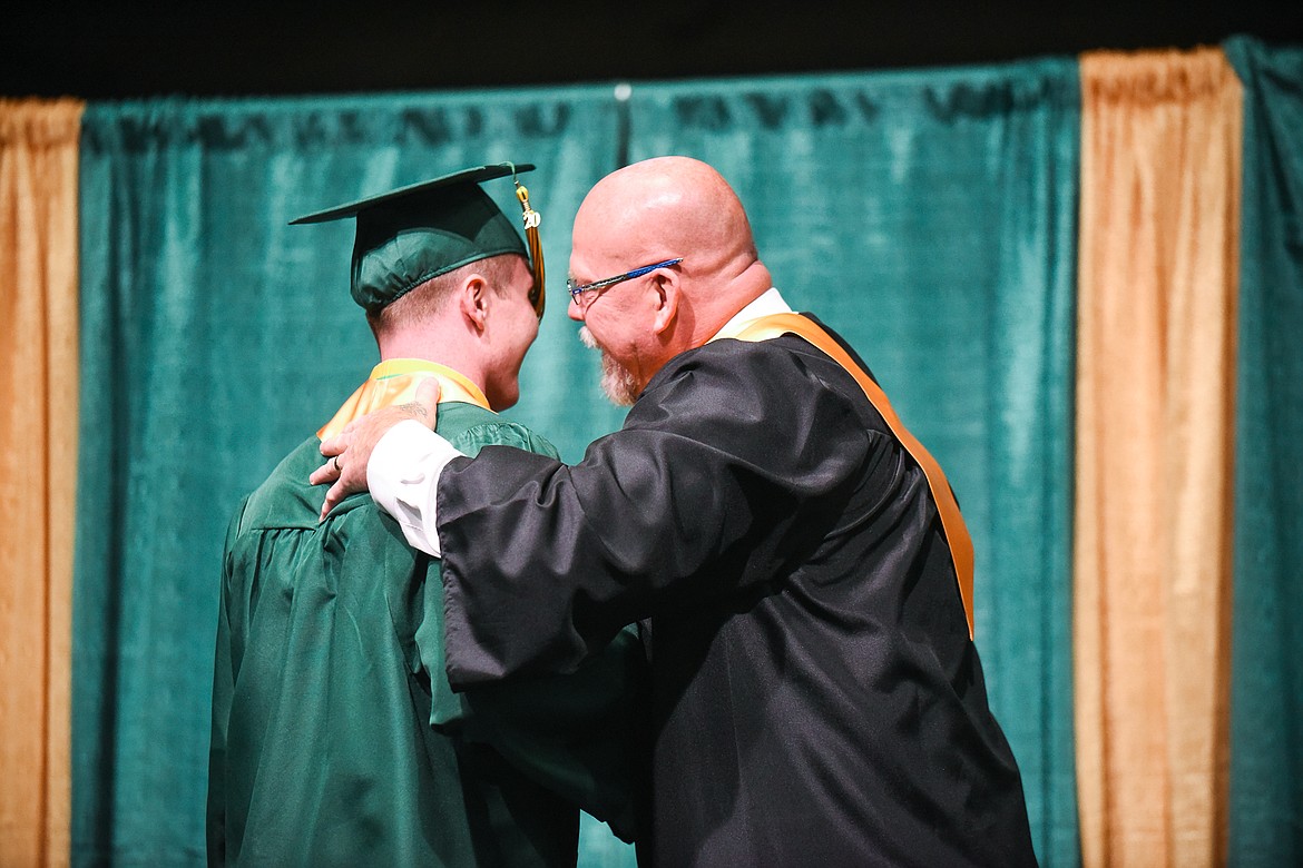 Whitefish High School Principal Kerry Drown shares a moment with his son, Logan, during Saturday's Whitefish High School Graduation. (Daniel McKay/Whitefish Pilot)