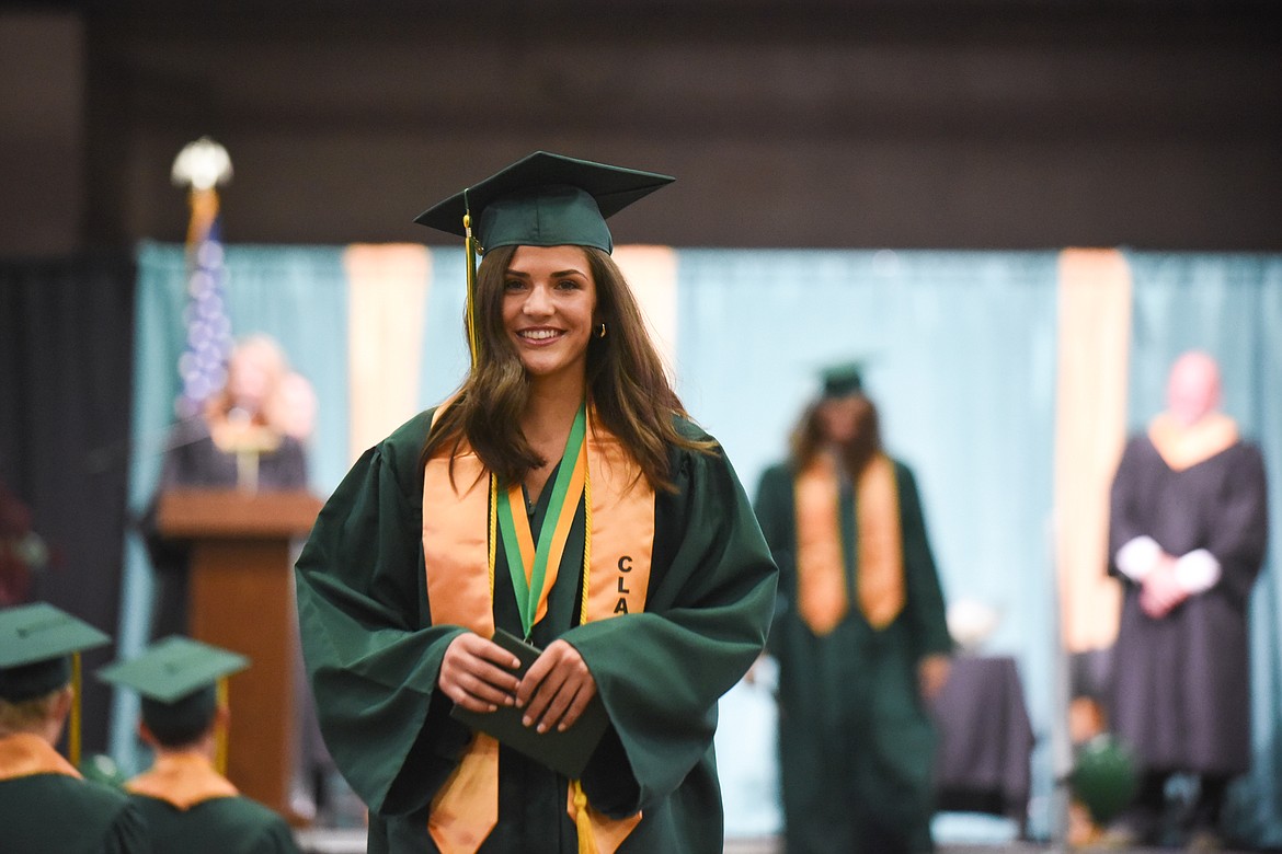 Whitefish High School senior Jesse Grawunder returns to her seat with a diploma in hand during the school's graduation ceremony, held at the Majestic Valley Arena on Saturday. (Daniel McKay/Whitefish Pilot